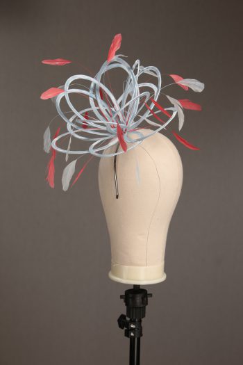 Ladies' formal Baby Blue and Coral Pink medium feather and satin loop fascinator hat. Suitable for a wedding or ladies' day at the races