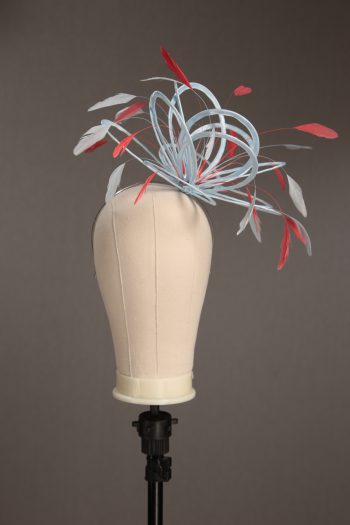 Ladies' formal Baby Blue and Coral Pink medium feather and satin loop fascinator hat. Suitable for a wedding or ladies' day at the races