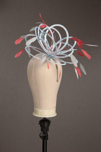 Ladies' formal Baby Blue and Coral Pink medium feather and satin loop fascinator hat. Suitable for a wedding or ladies' day at the races