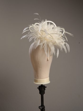 Ladies formal cream medium feather and satin loop fascinator hat. Suitable for a wedding or ladies day at the races