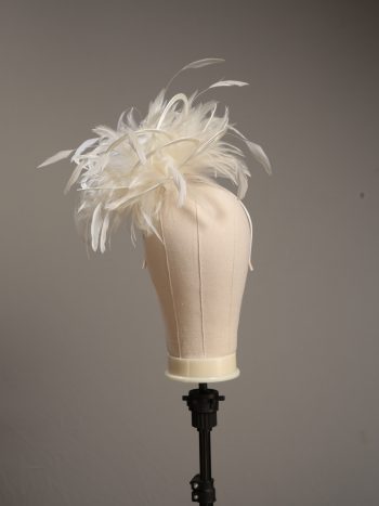 Ladies formal cream medium feather and satin loop fascinator hat. Suitable for a wedding or ladies day at the races