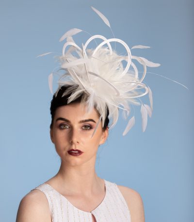 white satin loop and feather fascinator hat set on a headband