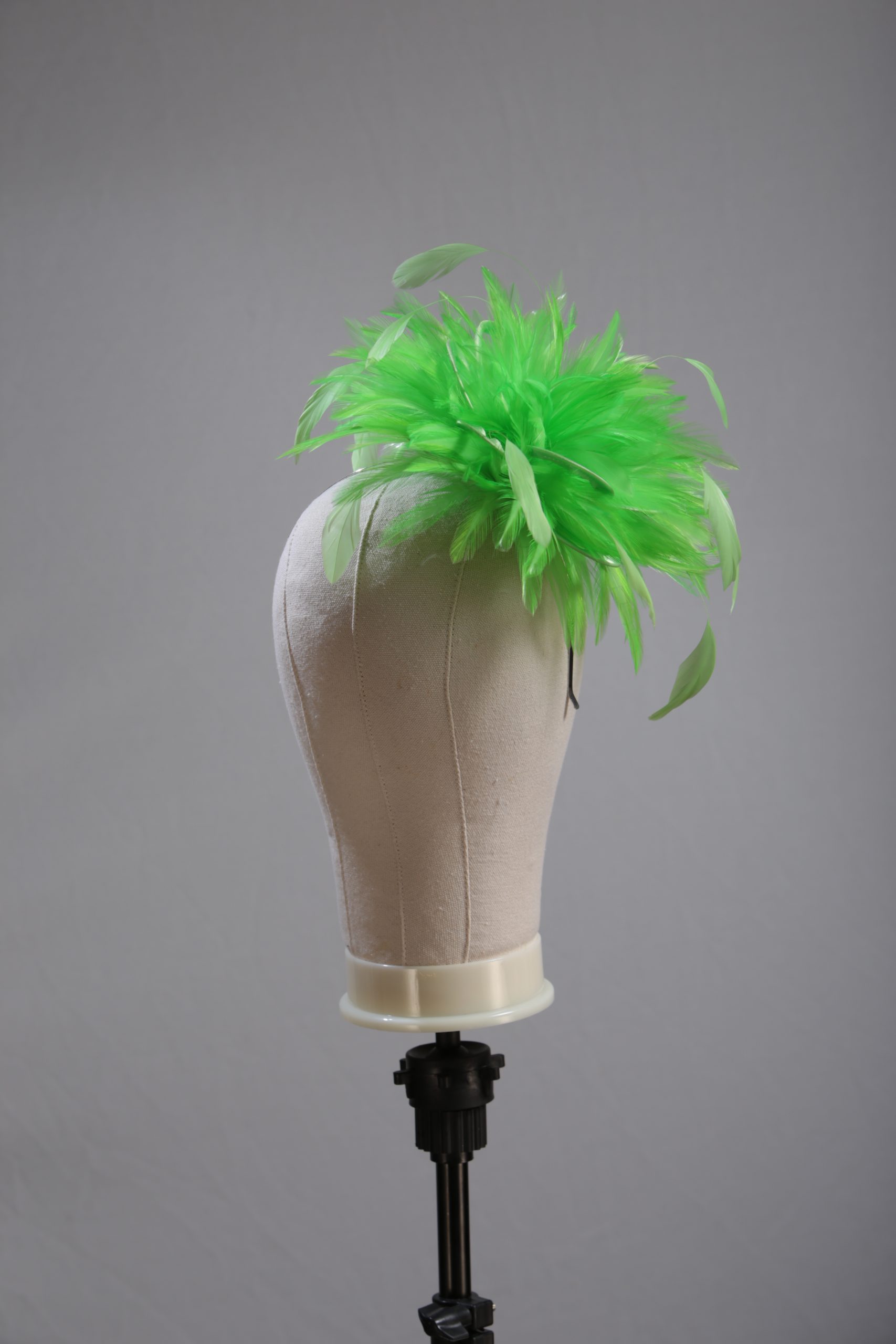 Ladies wedding or races apple lime green small feather and satin loop fascinator hat
