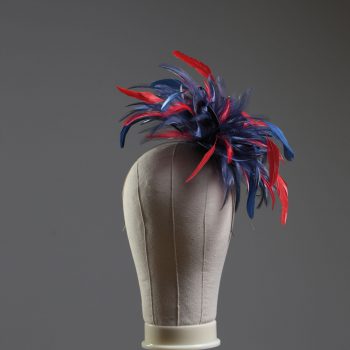 navy blue and red small hackle fascinator hat with feathers set on a headband