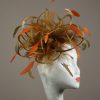 Gold satin Loop Fascinator Hat with gold and orange feathers