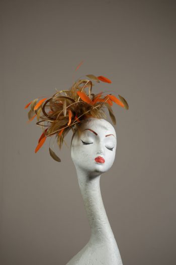 Gold satin Loop Fascinator Hat with gold and orange feathers