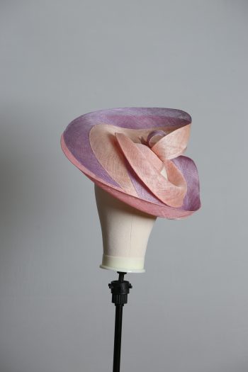 Pink lilac and oyster sinamay swirl fascinator hat set on a teardrop base