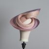 Pink lilac and oyster sinamay swirl fascinator hat set on a teardrop base