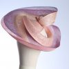 Pink lilac and oyster sinamay swirl fascinator hat set on a teardrop base