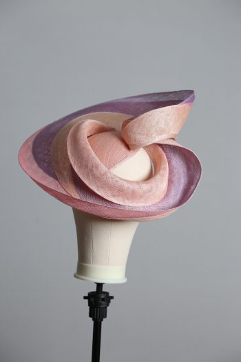 Pink lilac and oyster sinamay swirl fascinator hat set on a teardrop base