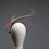 Rainbow multi-coloured quill floating fascinator hat set on a headband