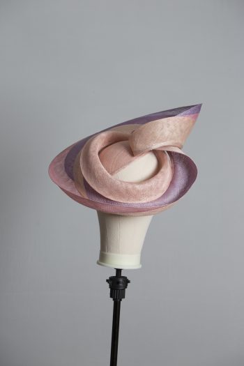 Pink lilac and oyster sinamay swirl fascinator hat set on a teardrop base