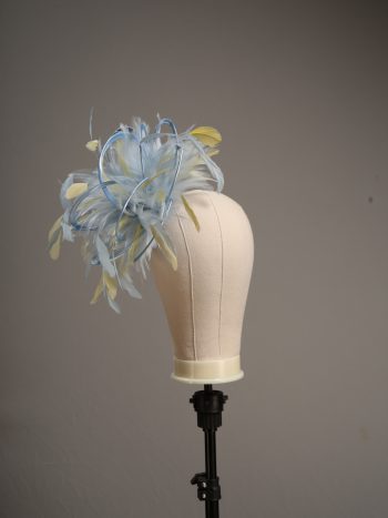 Ladies formal Baby blue and yellow medium feather and satin loop fascinator hat. Suitable for a wedding or ladies day at the races