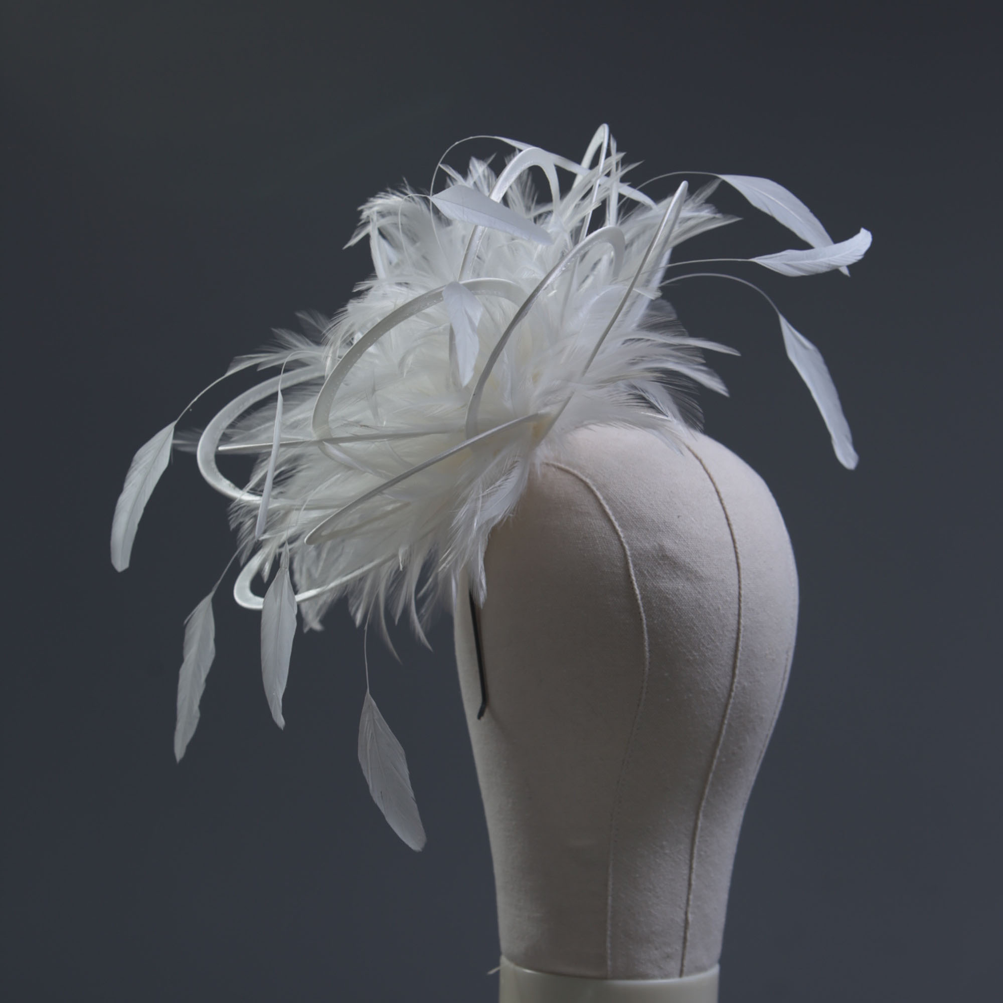 Ladies formal Ivory medium feather and satin loop fascinator hat. Suitable for a wedding or ladies day at the races