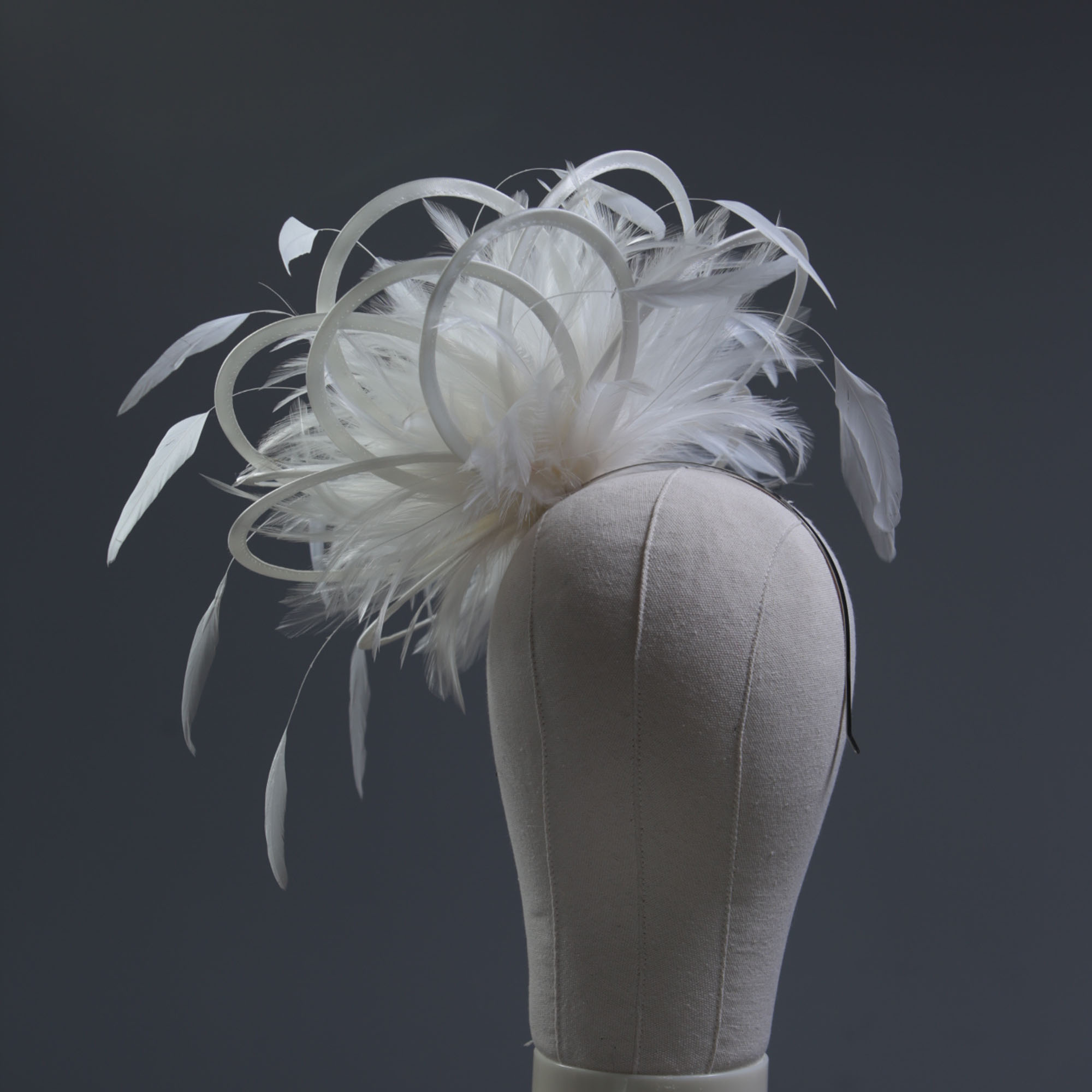 Ladies formal Ivory medium feather and satin loop fascinator hat. Suitable for a wedding or ladies day at the races