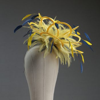 Ladies formal yellow and navy blue medium feather and satin loop fascinator hat. Suitable for a wedding or ladies day at the races