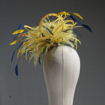 Ladies formal yellow and navy blue medium feather and satin loop fascinator hat. Suitable for a wedding or ladies day at the races