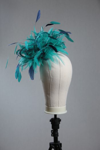 Ladies' formal Turquoise and Navy Blue medium feather and satin loop fascinator hat. Suitable for a wedding or ladies' day at the races