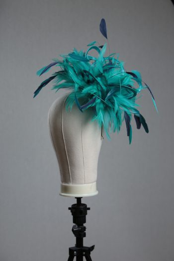 Ladies' formal Turquoise and Navy Blue medium feather and satin loop fascinator hat. Suitable for a wedding or ladies' day at the races