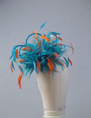 Ladies' formal Turquoise and Orange medium feather and satin loop fascinator hat. Suitable for a wedding or ladies' day at the races