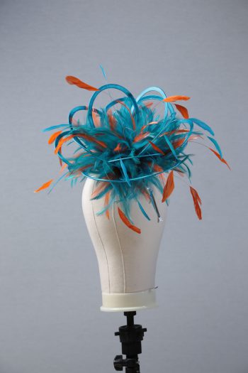 Ladies' formal Turquoise and Orange medium feather and satin loop fascinator hat. Suitable for a wedding or ladies' day at the races