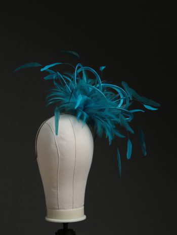 Ladies' formal Turquoise and Teal medium feather and satin loop fascinator hat. Suitable for a wedding or ladies' day at the races