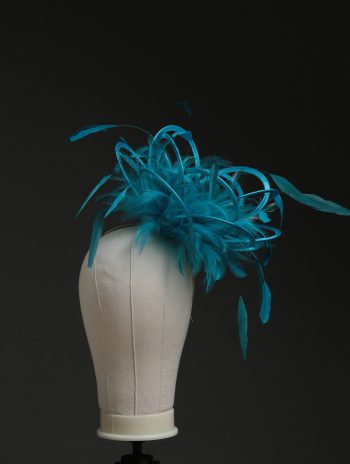 Ladies' formal Turquoise and Teal medium feather and satin loop fascinator hat. Suitable for a wedding or ladies' day at the races