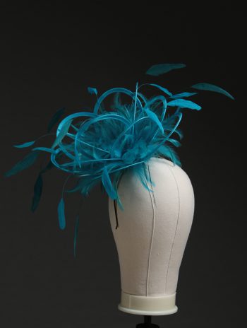 Ladies' formal Turquoise and Teal medium feather and satin loop fascinator hat. Suitable for a wedding or ladies' day at the races