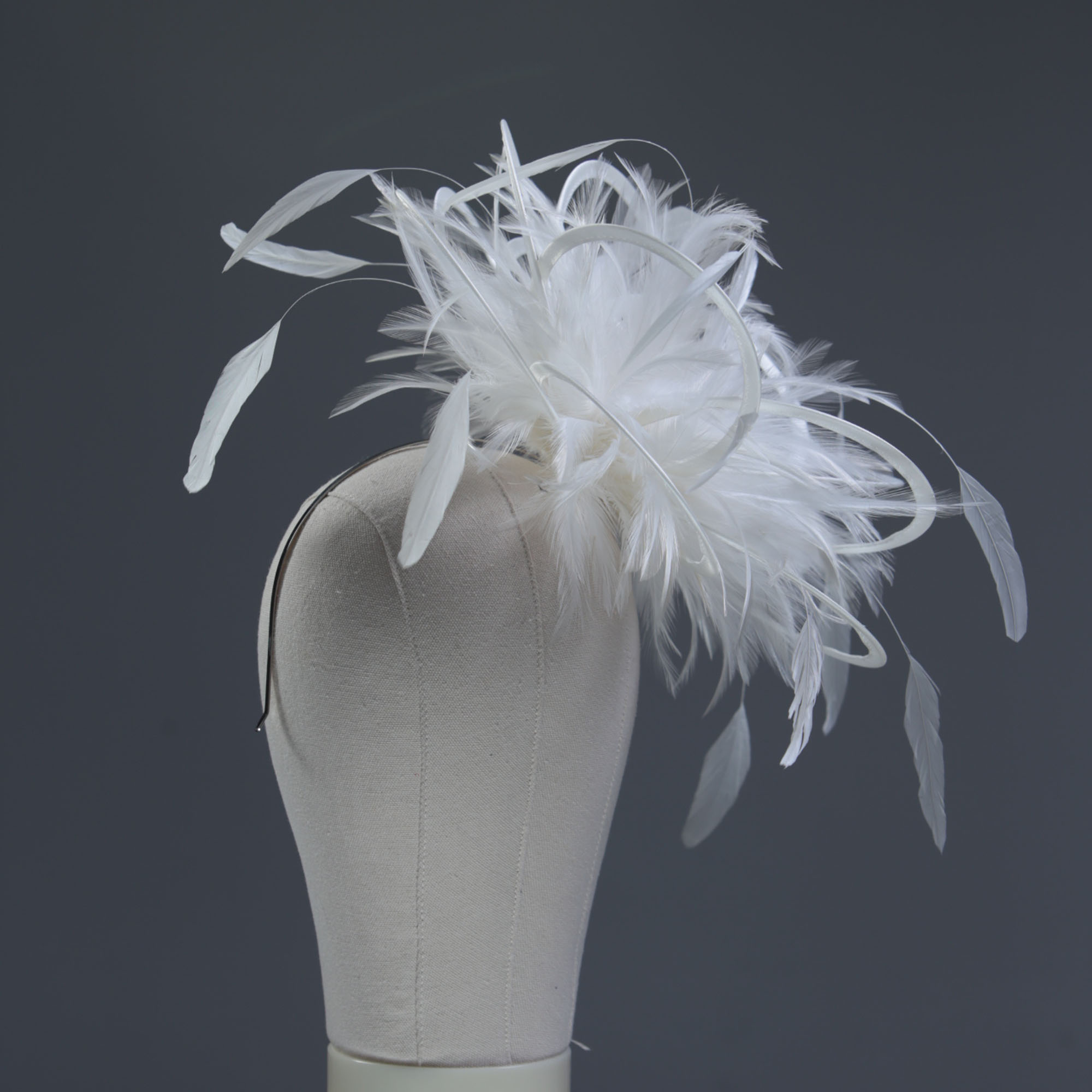 Ladies formal Ivory medium feather and satin loop fascinator hat. Suitable for a wedding or ladies day at the races