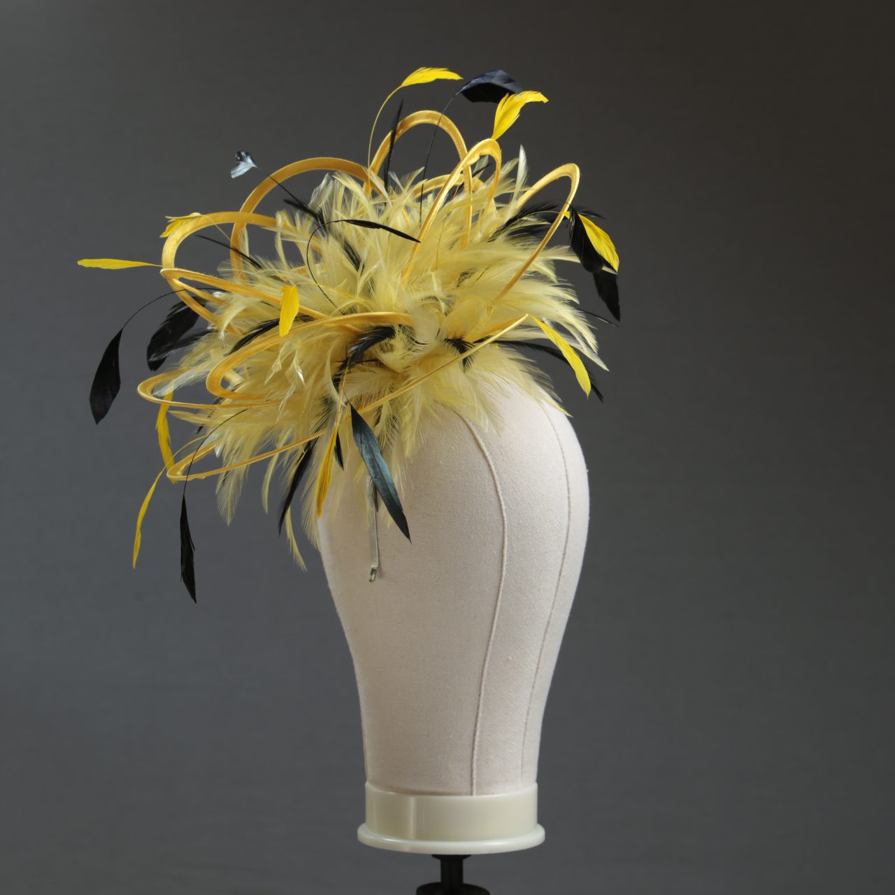 Ladies formal yellow and black medium feather and satin loop fascinator hat. Suitable for a wedding or ladies day at the races