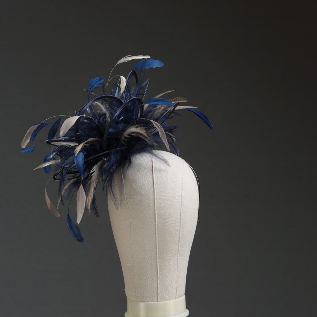 Ladies' formal Navy Blue and Taupe Nude medium feather and satin loop fascinator hat. Suitable for a wedding or ladies' day at the races