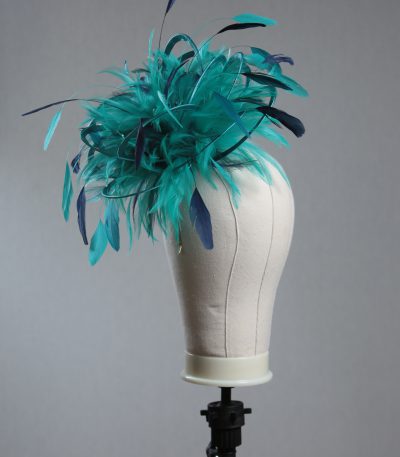 Ladies' formal Turquoise and Navy Blue medium feather and satin loop fascinator hat. Suitable for a wedding or ladies' day at the races